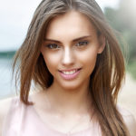 Portrait close up of a beautiful smiling girl with nice hair