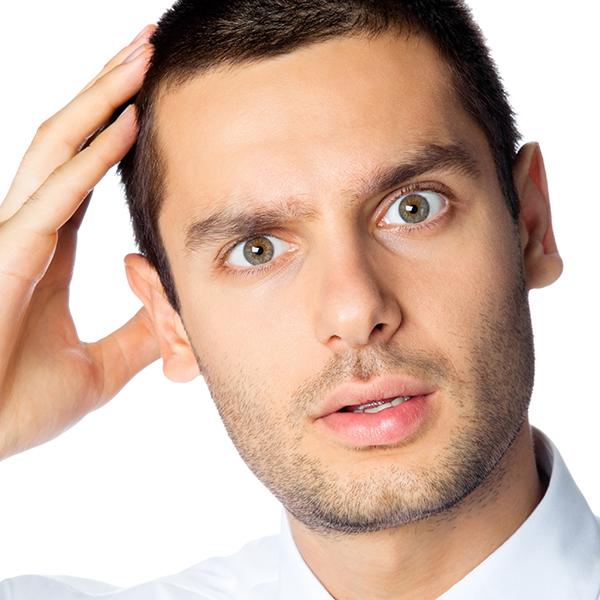 Portrait of confused or thinking young businessman, isolated over white background