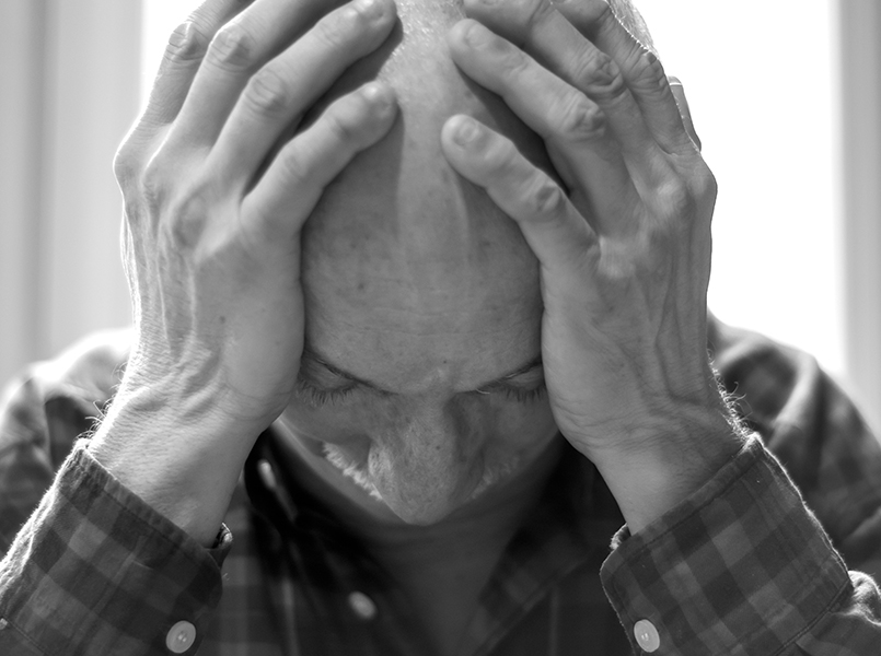 Senior bald man suffering from pain at home