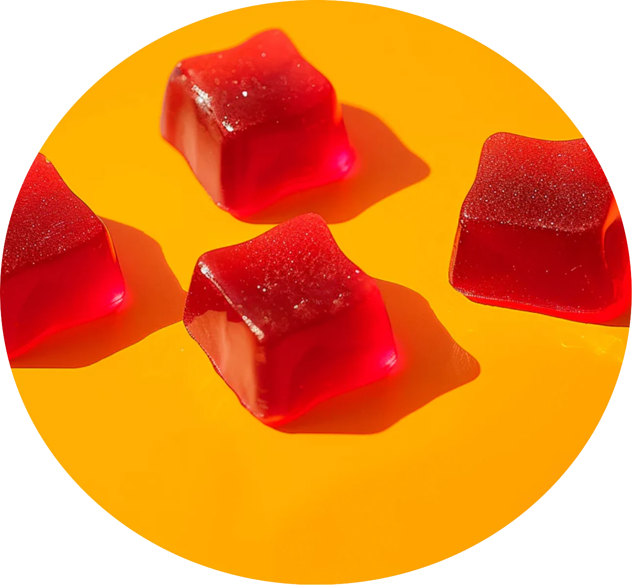 Red star-shaped gummy supplements on bright yellow surface